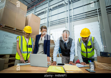 Warehouse workers and managers working in warehouse Stock Photo