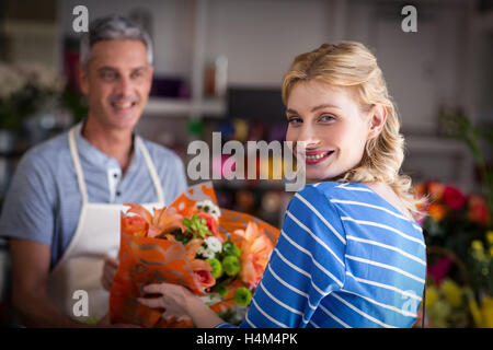 Florist giving bouquet of flower to customer Stock Photo
