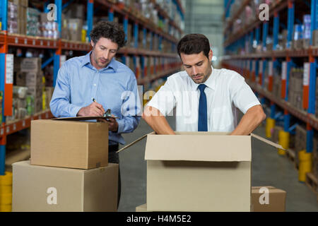 Two warehouse workers checking the boxes Stock Photo