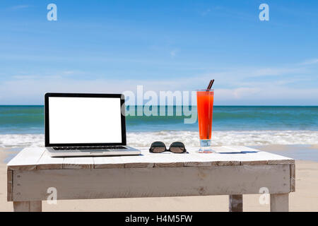 Working on the beach, white blank screen for copy-space Stock Photo