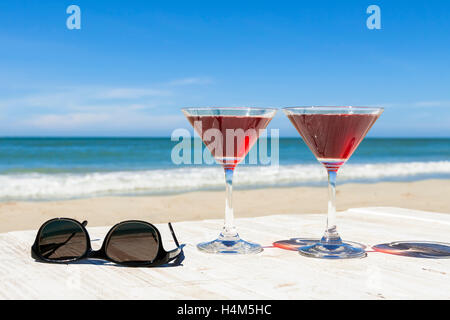 Two cocktails and sunglasses at a beach restaurant, tropical leisure Stock Photo