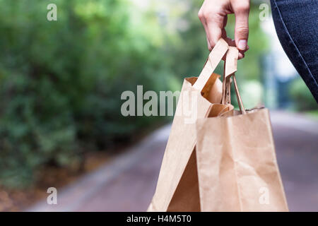 Girl doing ecological shopping with paper bags in hand Stock Photo