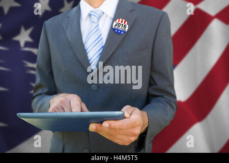 Composite image of midsection of businessman using digital tablet Stock Photo