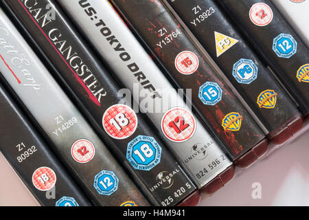 Various age classification ratings on row of HD DVD cases - PG parental guidance 12 15 18 Stock Photo