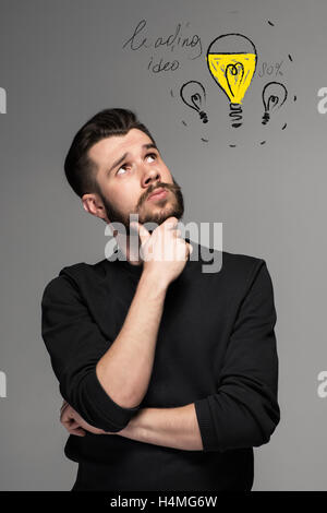 Man is looking reminiscing. Over gray background Stock Photo