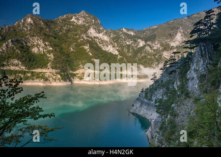 Morning fog at Piva Lake (Pivsko jezero), artificial lake on Piva river in Piva Canyon, Montenegro Stock Photo