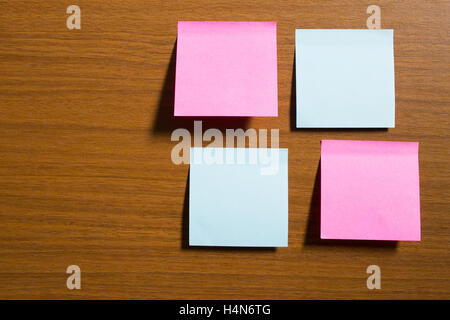 Sticky notes stick on wooden texture Stock Photo