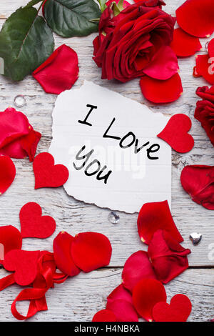 I love you card on wooden board with petals Stock Photo