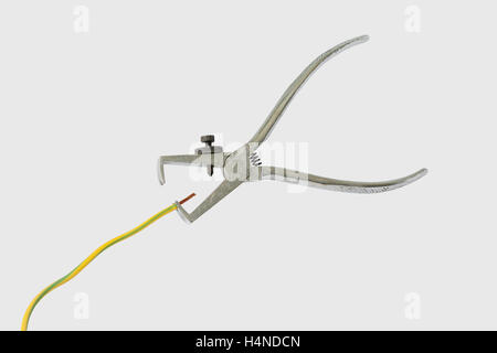 Electrician tools stripper. Isolated on a gray background. Stock Photo