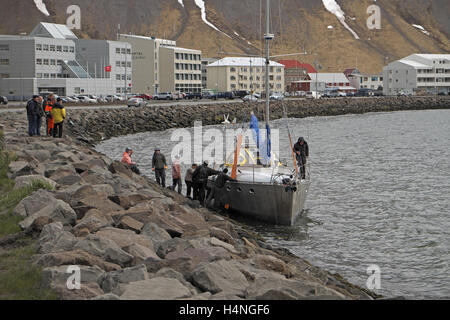 A yacht in danger of being blown on to the rocks, Isafjordur, Isafjordardjup, Westfjords, Iceland. Stock Photo