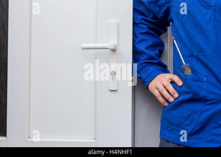 Detail of male contractor in blue work clothes Stock Photo