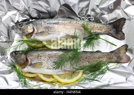 grilled whole rainbow trout with vegetables on grill pan Stock Photo