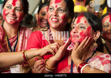 The image of Bengali Woman hindu devotee playing sindoor khela on the traditional festival of Bijoya Dasami, Dussehra, Mumbai, I Stock Photo