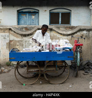 MADURAJ, TAMILNADU, INDIA -MARCH 05: Indian ironing clothes in the street in India in Madurai city in the Tamilnadu Stock Photo