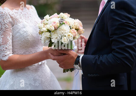 bride and groom holding hands in wedding day Stock Photo