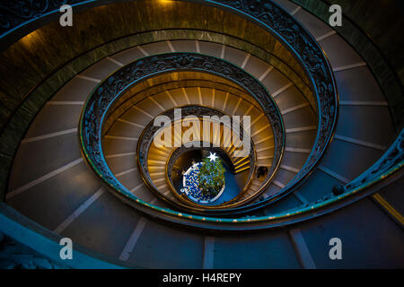 Man descending double staircase Stock Photo