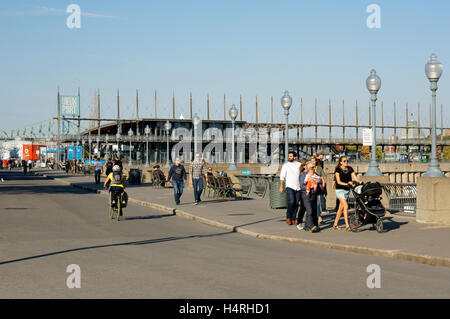 People on the Promenade des Artistes with Jacques Cartier Pavilion in back, Old Port of Montreal, Quebec, Canada Stock Photo
