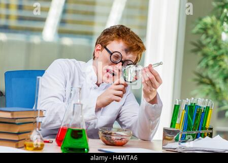 Young crazy chemist working in the lab Stock Photo