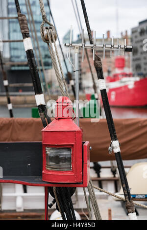 Vintage red ship's lantern with TV aerial on tall ship in Albert Dock Liverpool is an incongrous mixture Stock Photo