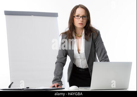 Businesswoman with a laptop and a flipchart Stock Photo