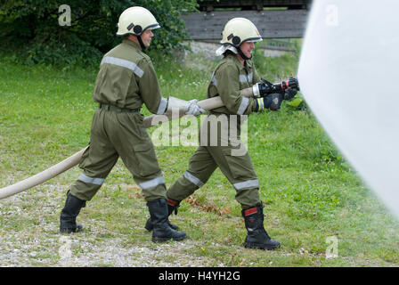 Volunteer Fire Brigade with a water hose, Reichraming, Upper Austria, Austria, Europe Stock Photo