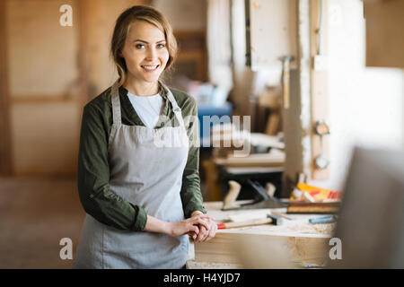 Young woodworker in uniform looking at camera Stock Photo