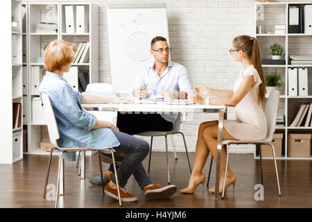 Young managers discussing ideas for new creative project Stock Photo
