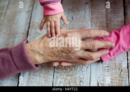 Hands of unrecognizable grandmother and her granddaughters Stock Photo