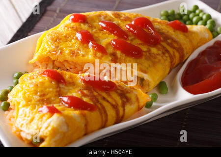 Japanese omelet with rice and ketchup Omurice close-up on a plate. horizontal Stock Photo