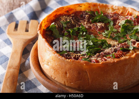 Homemade Chicago deep dish pizza closeup on a plate on the table. Horizontal Stock Photo