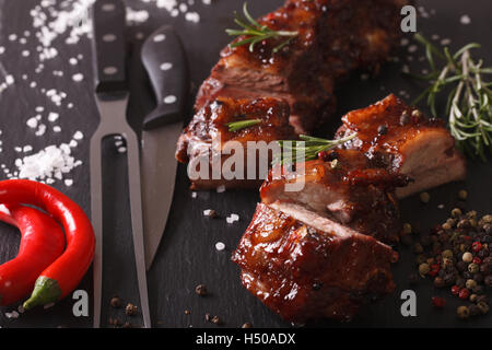 Spicy pork ribs BBQ closeup on the table with the ingredients. horizontal Stock Photo