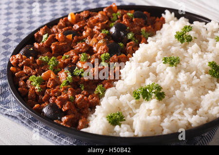 Cuban food: Picadillo a la habanera with a side dish of rice close-up on a plate. horizontal Stock Photo