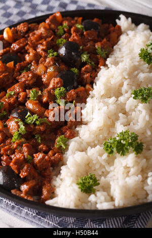 Latin American cuisine: Picadillo a la habanera with a side dish of rice macro. Vertical Stock Photo