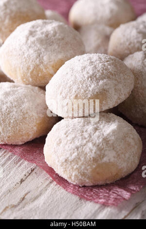 polvoron cookies with powdered sugar macro on a wooden table. Vertical Stock Photo