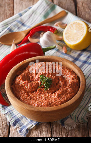 Red Muhammara and ingredients close-up on the table. vertical Stock Photo