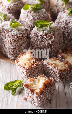 Australian Lamington cake decorated with mint close up on the table. vertical Stock Photo