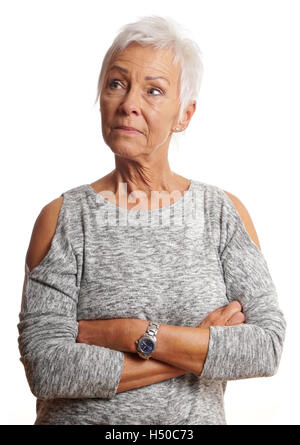mature woman with arms folded looking away Stock Photo