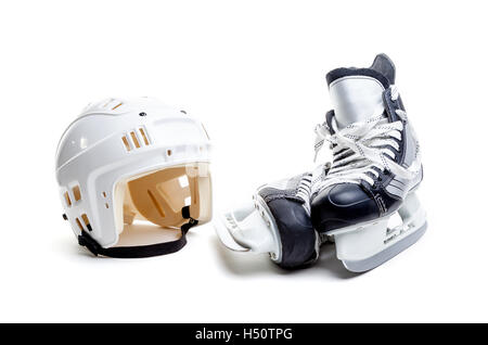 Ice hockey helmet and a pair of ice skates isolated on white background. Stock Photo