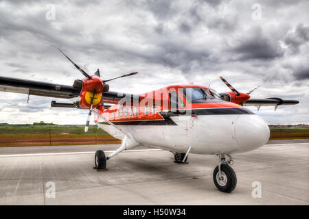 Vintage propeller plane on an airport tarmac ready for takeoff Stock Photo