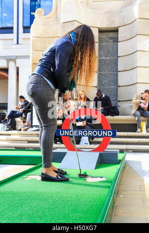 Paternoster Square, City of London, UK, 18th Oct 2016. City workers and visitors enjoy a round of crazy golf on Paternoster Square near St Paul's Cathedral in the City of London. The event is free for all to play and remains at Paternoster Square from 18th Oct to 21st Oct with competitions and a play off cup. The course includes a miniature Tower Bridge, London Eye and other iconic buiildings Credit:  Imageplotter News and Sports/Ģ����ý Live News Stock Photo