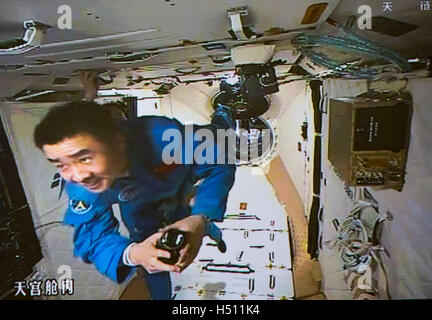 Beijing, China. 19th Oct, 2016. Photo taken on Oct. 19, 2016 shows the screen at the Beijing Aerospace Control Center showing Chinese astronaut Chen Dong in the space lab Tiangong-2. The two astronauts onboard the Shenzhou-11 spacecraft entered the space lab Tiangong-2 Wednesday morning. © Ju Zhenhua/Xinhua/Alamy Live News Stock Photo