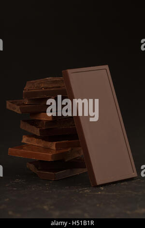 Front view of square shaped chocolate pieces isolated on dark background Stock Photo