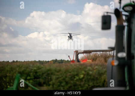 A Chinook HC4 operated by 28 Squadron RAF Benson, Oxfordshire, UK flies over farmland in West Hanney, Oxfordshire, UK Stock Photo