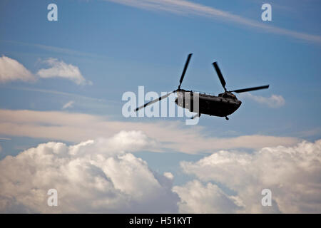 A Chinook HC4 operated by 28 Squadron RAF Benson, Oxfordshire, UK flies over farmland in West Hanney, Oxfordshire, UK Stock Photo