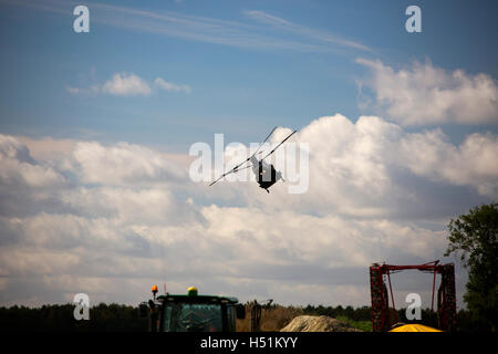 A Chinook HC4 operated by 28 Squadron RAF Benson, Oxfordshire, UK flies over farmland in West Hanney, Oxfordshire, UK Stock Photo