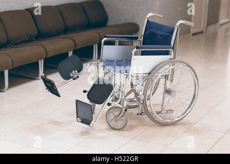 Empty wheelchair parked in hospital Stock Photo
