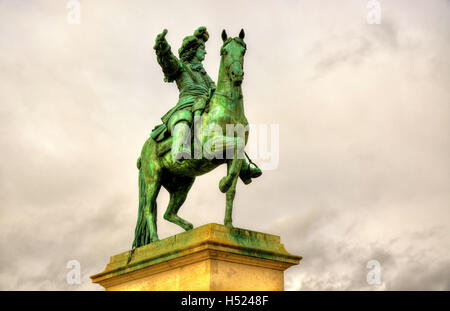 Statue of Louis XIV in front of the Palace of Versailles near Pa Stock Photo