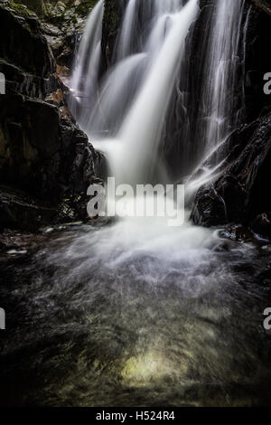 Waterfall in a secret cavern in the English Lake District Stock Photo