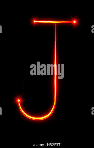 red thin light painting letter J on black background Stock Photo