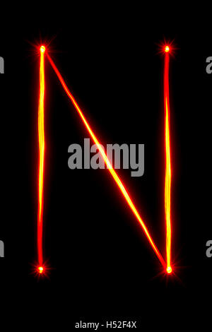red thin light painting letter N on black background Stock Photo